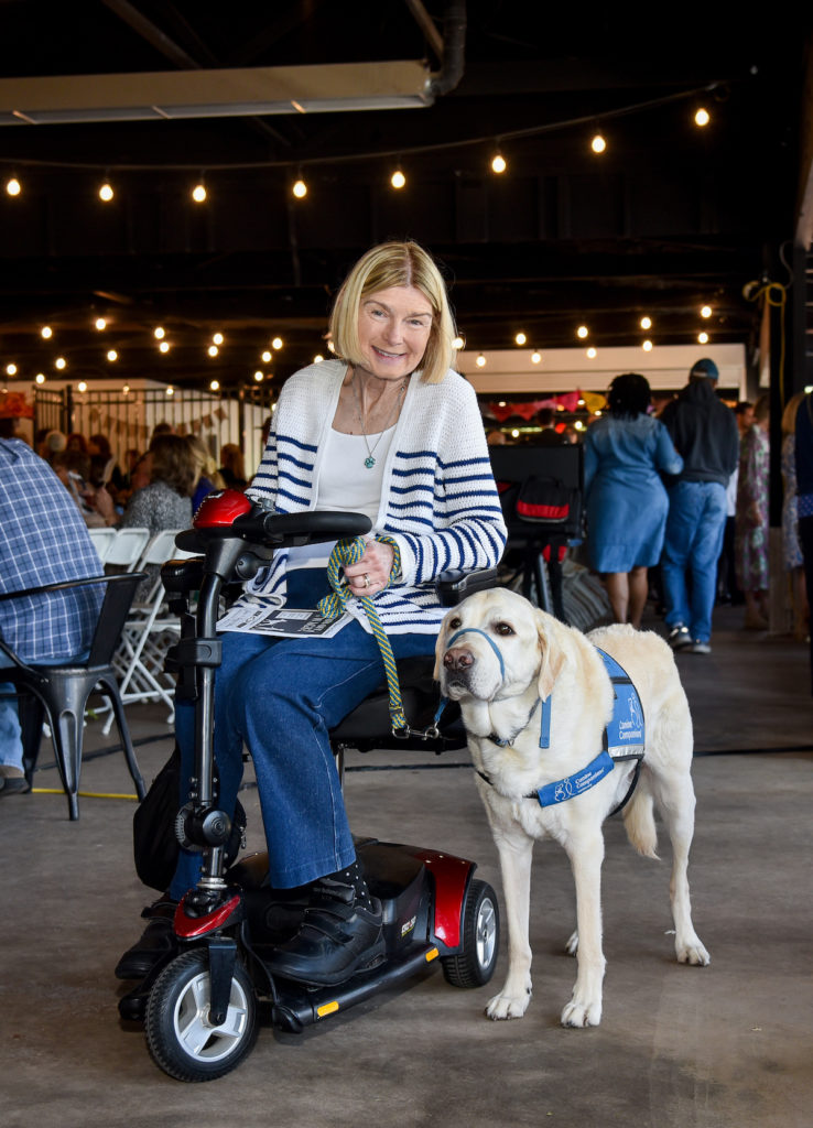 Member of WAGS brings her own cream Labrador service dog to the event