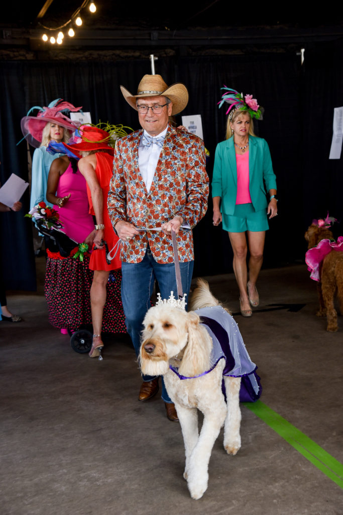 Cowboy dressed in blazer with doodle Nala crowned with a tiara.