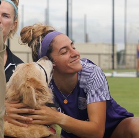 Visiting pet kisses a soccer player for encouragement